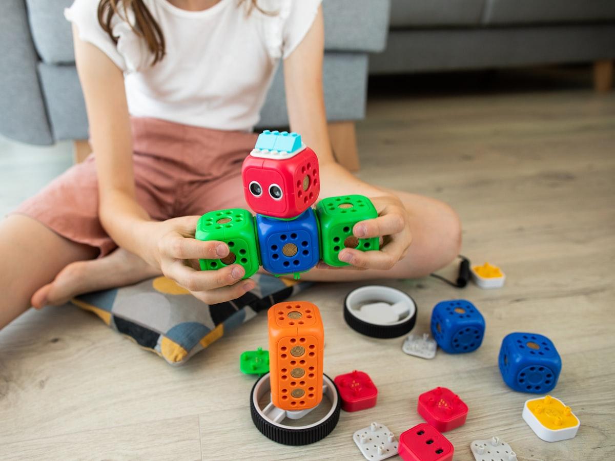 A child assembling a modular robot kit
